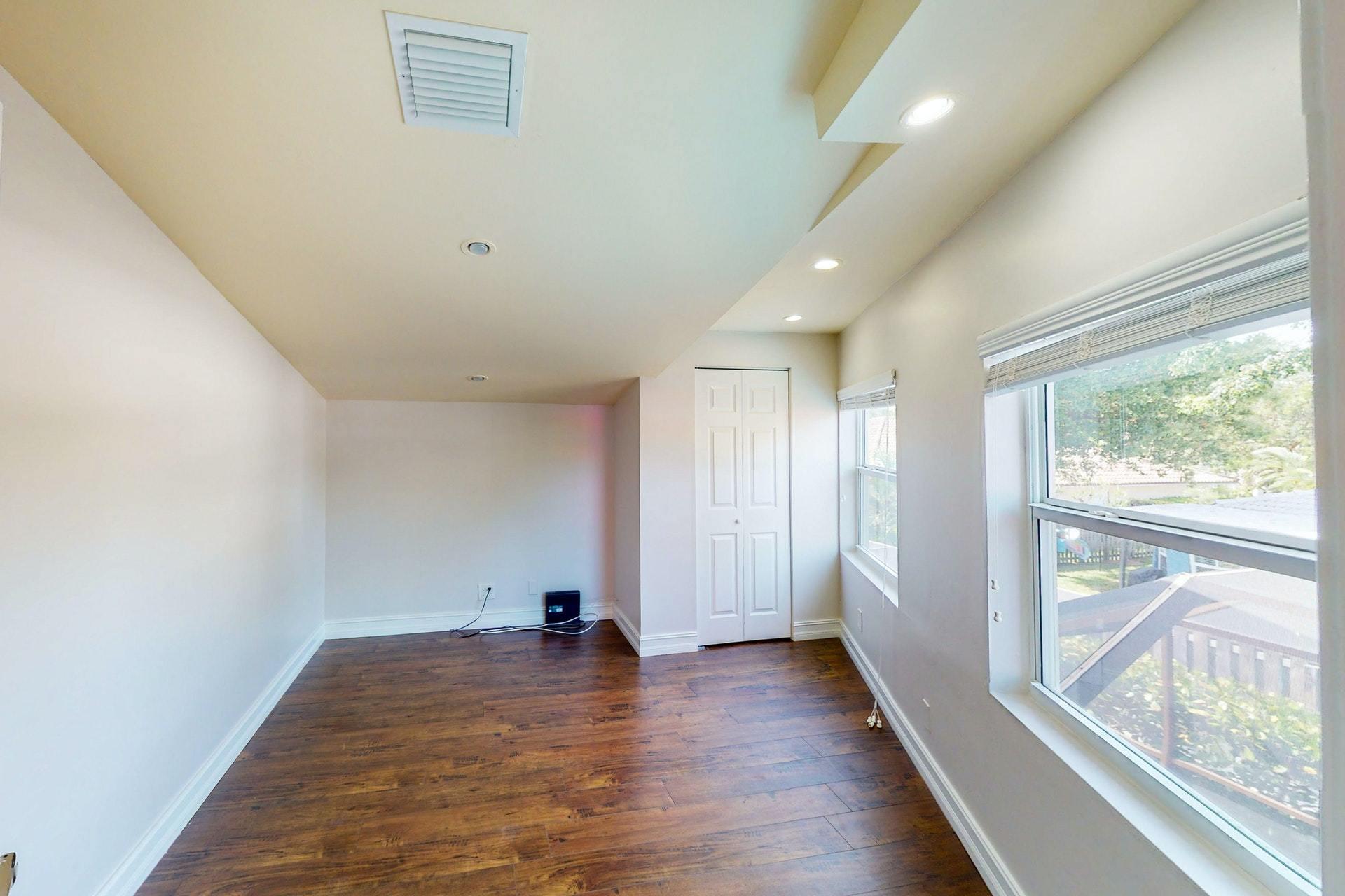 1339 Southwest 3rd Street Boca Raton, FL 33486 - Photo 40 of 56 a view of empty room with wooden floor and fan