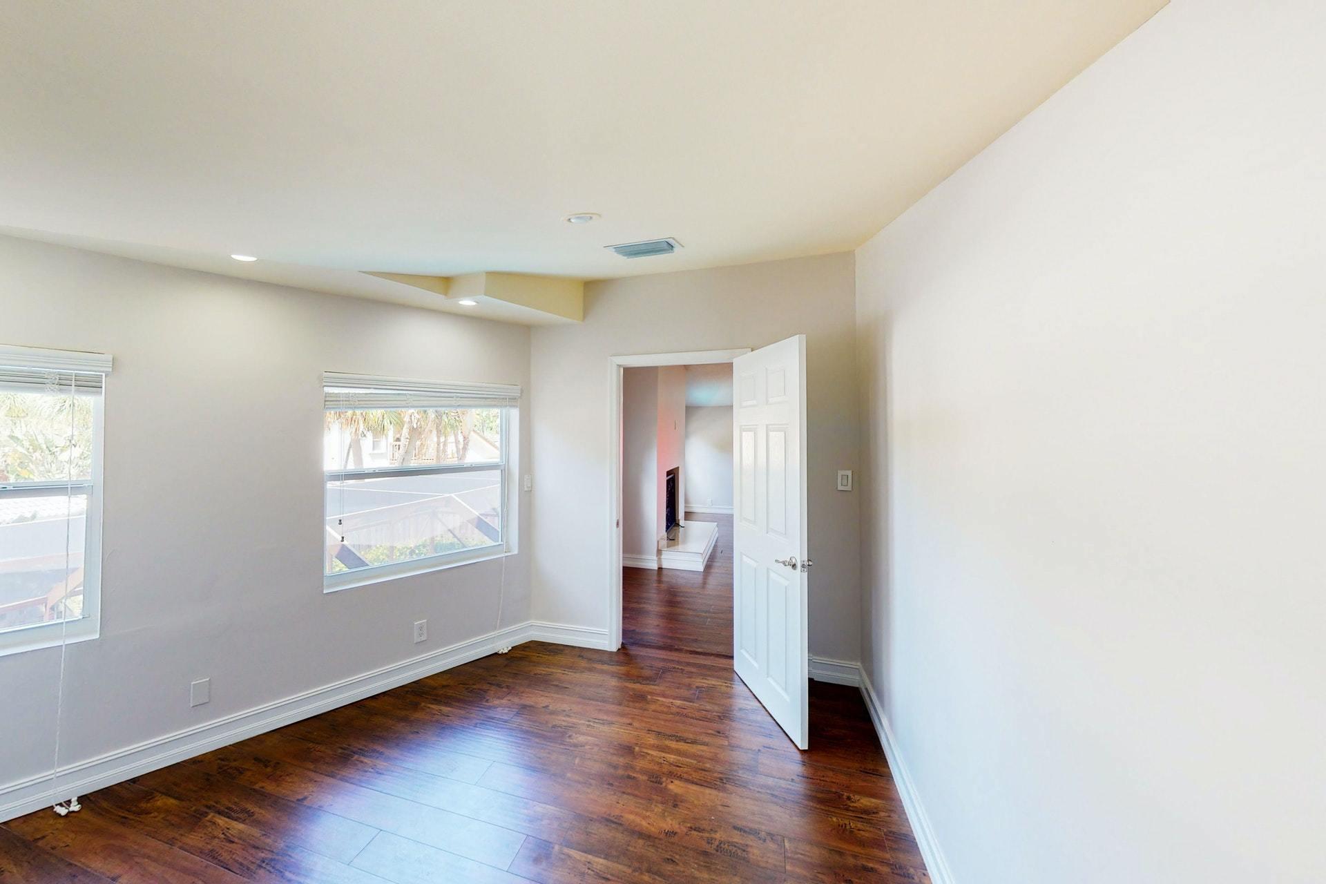 1339 Southwest 3rd Street Boca Raton, FL 33486 - Photo 41 of 56 a view of an empty room with wooden floor and a window