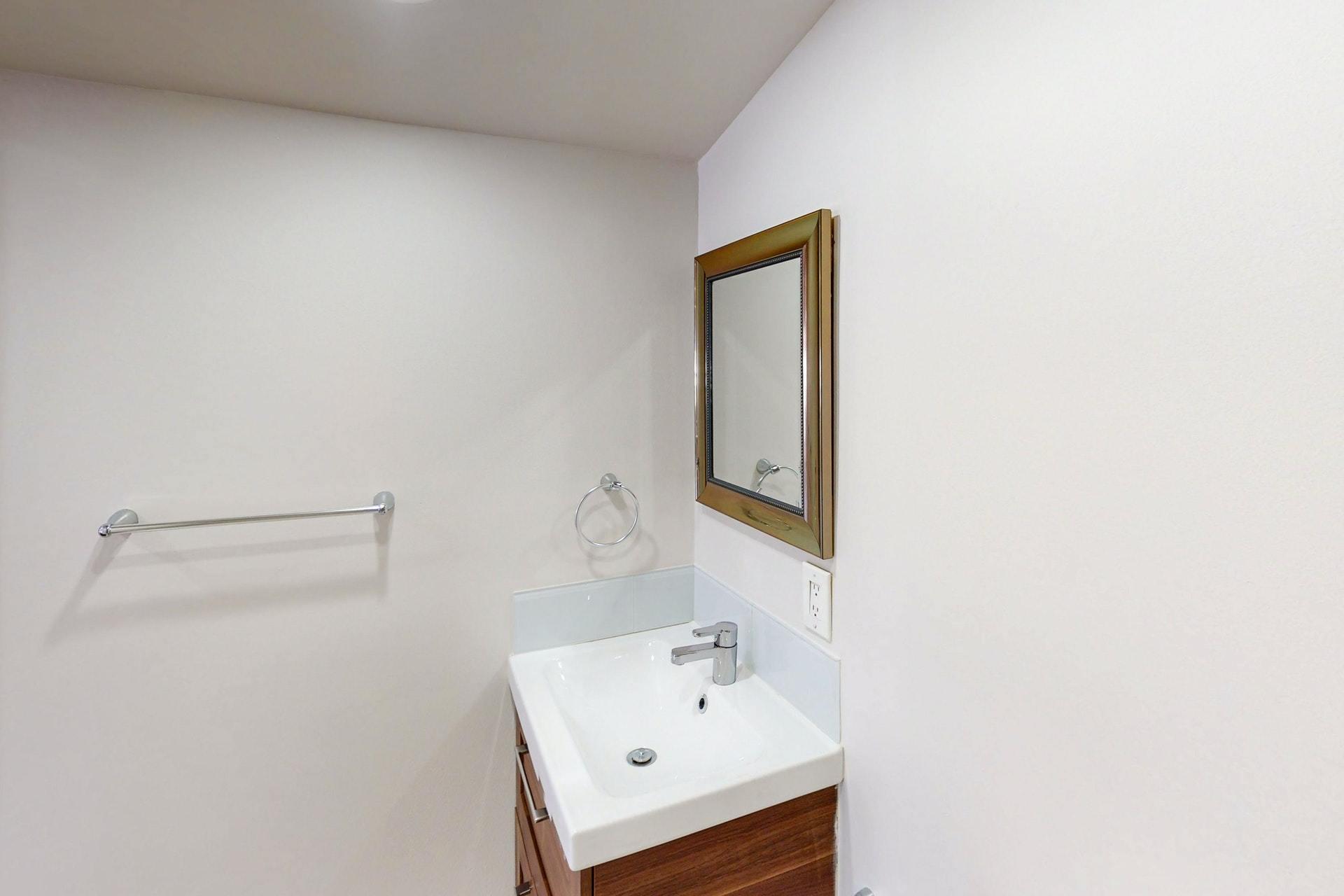 1339 Southwest 3rd Street Boca Raton, FL 33486 - Photo 44 of 56 a bathroom with a sink a mirror and vanity