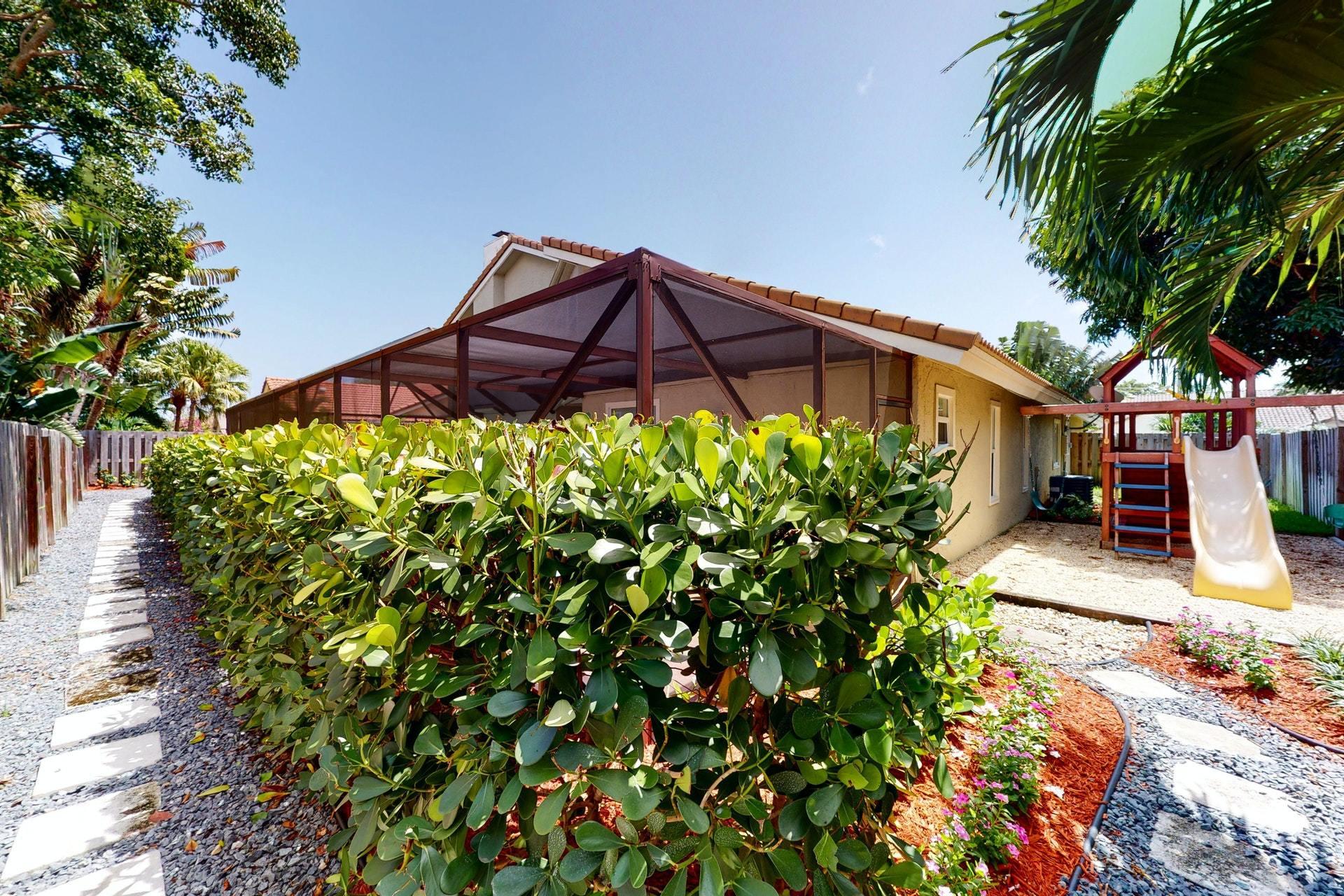 1339 Southwest 3rd Street Boca Raton, FL 33486 - Photo 54 of 56 a front view of a house with a yard
