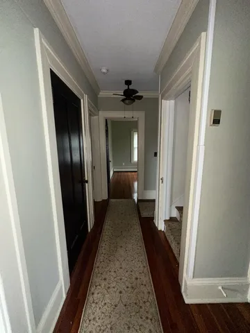 view of a hallway view with wooden floor and staircase