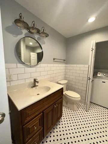 a bathroom with a sink toilet and mirror