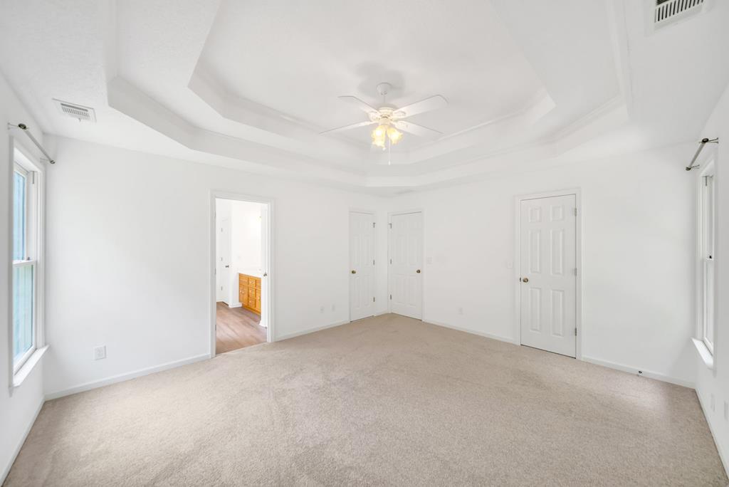 750 Cable Road Waleska, GA 30183 - Photo 11 of 33 an empty room with a ceiling fan and a window