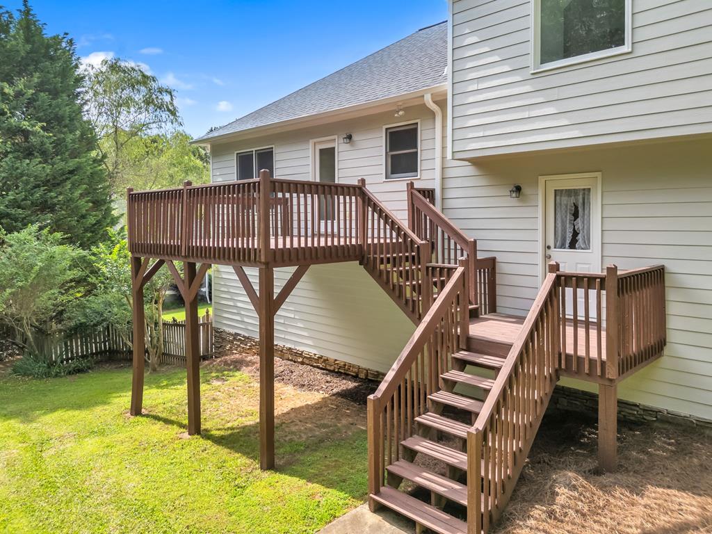 750 Cable Road Waleska, GA 30183 - Photo 23 of 33 a view of a roof deck with table and chairs with wooden floor and fence
