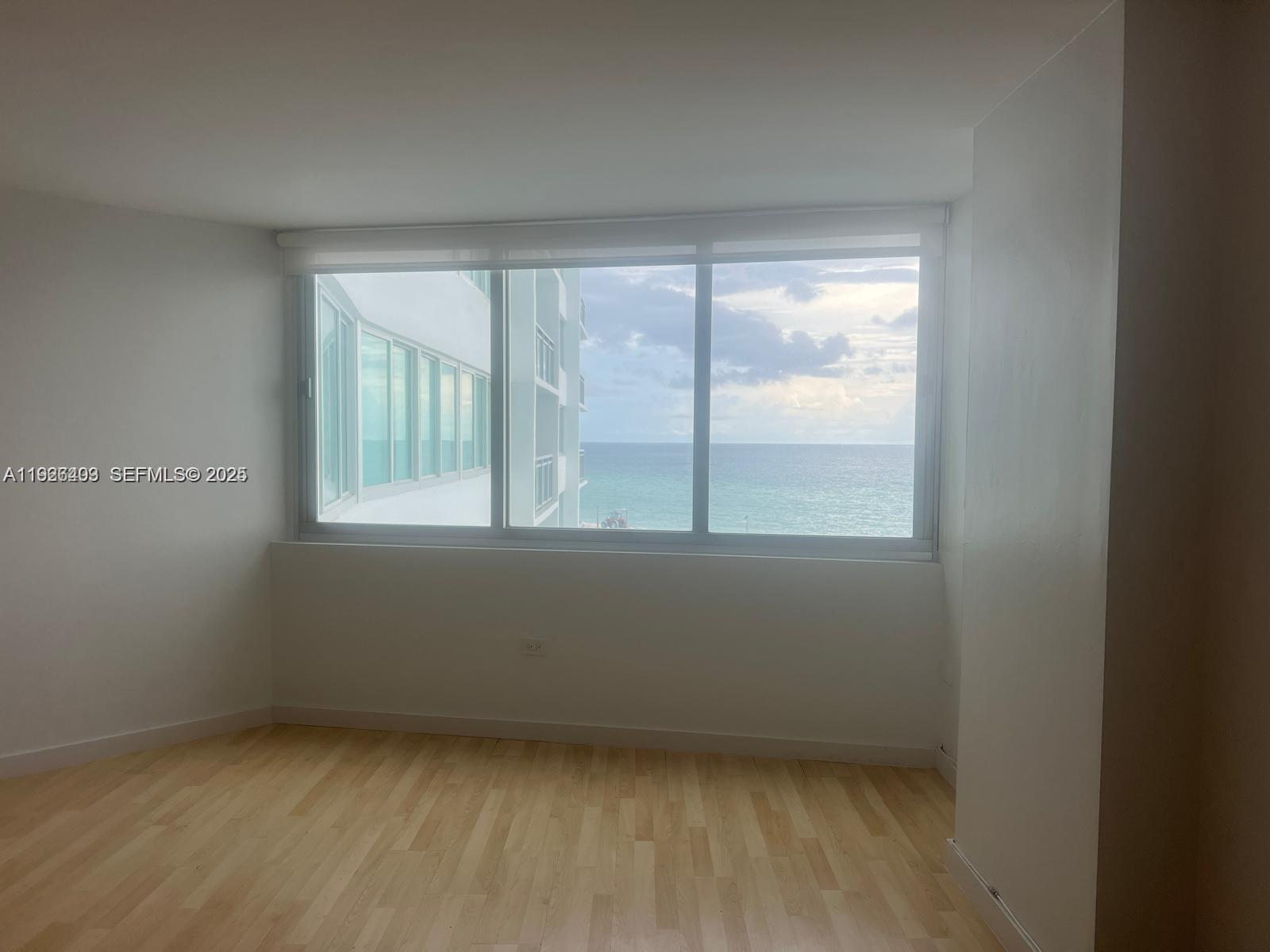 7135 Collins Avenue, Unit 512 Miami Beach, FL 33141 - Photo 2 of 10 an empty room with a window