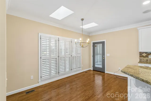 a view of empty room with wooden floor and fireplace
