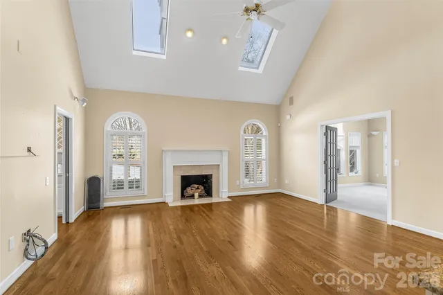 a kitchen that has a lot of cabinets and wooden floor