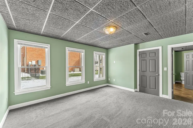 a view of a house with a yard and tree s