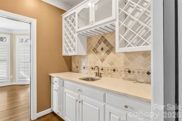 a view of kitchen with wooden floor and cabinets