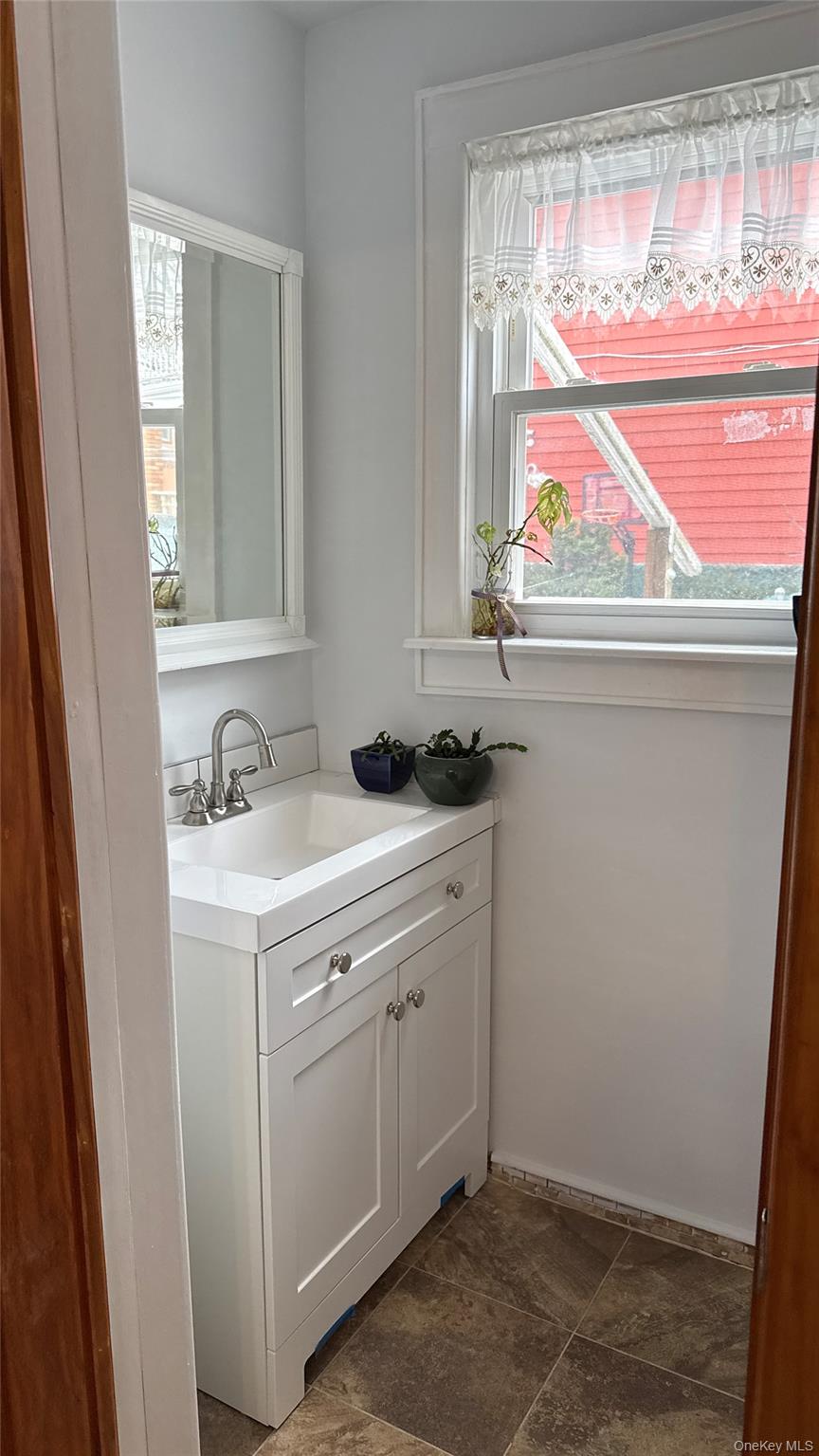 88-10 78th Street Queens, NY 11421 - Photo 11 of 19 a view of a sink and a window