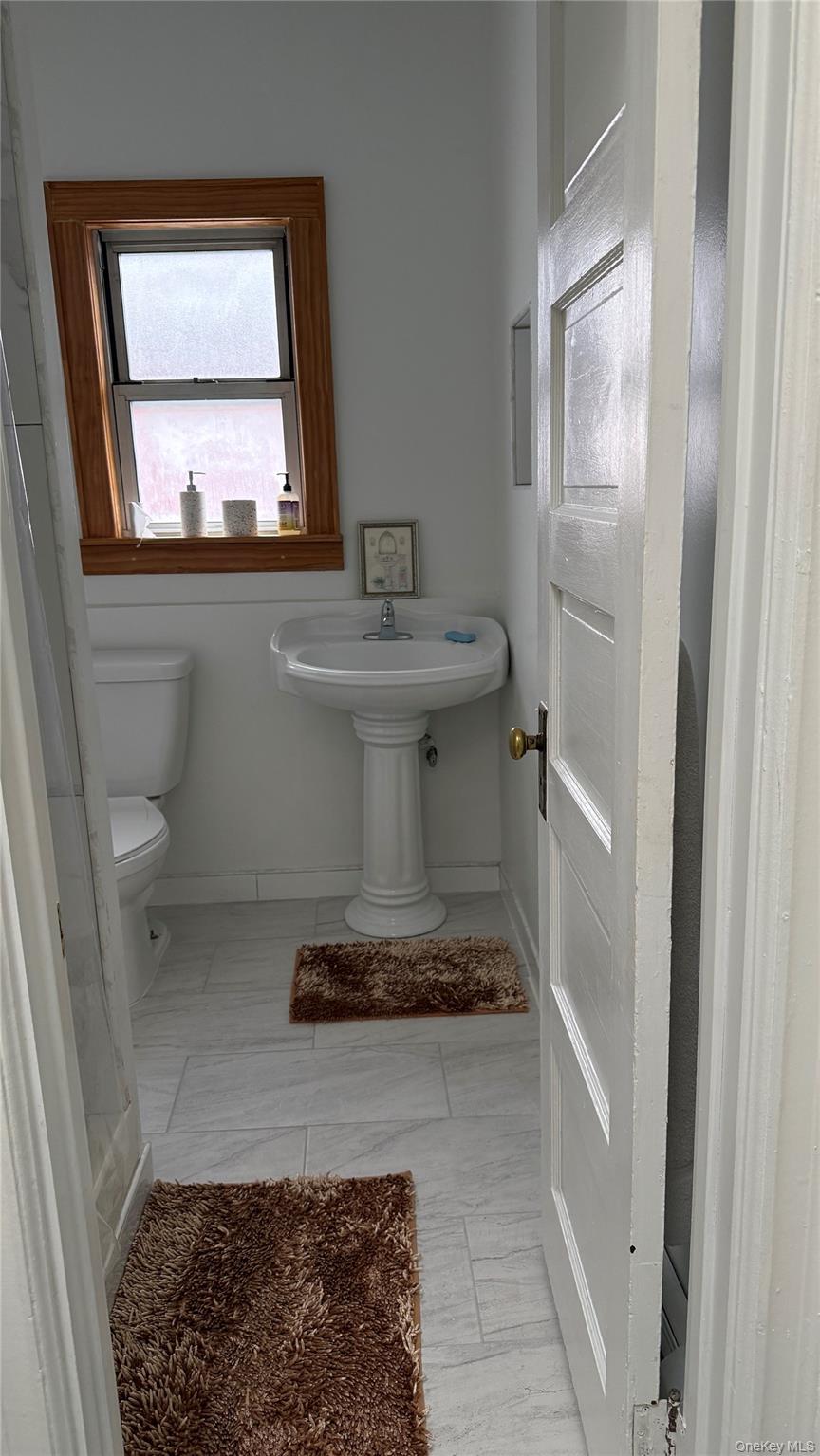 88-10 78th Street Queens, NY 11421 - Photo 13 of 19 a bathroom with a sink and a mirror