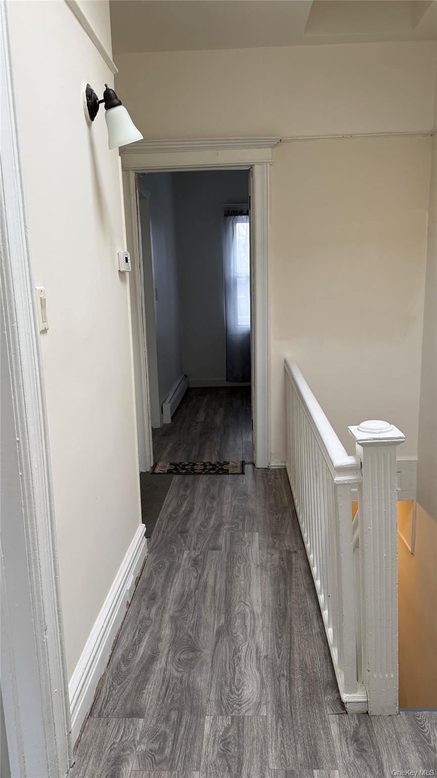 88-10 78th Street Queens, NY 11421 - Photo 15 of 19 a view of a hallway view with wooden floor and staircase