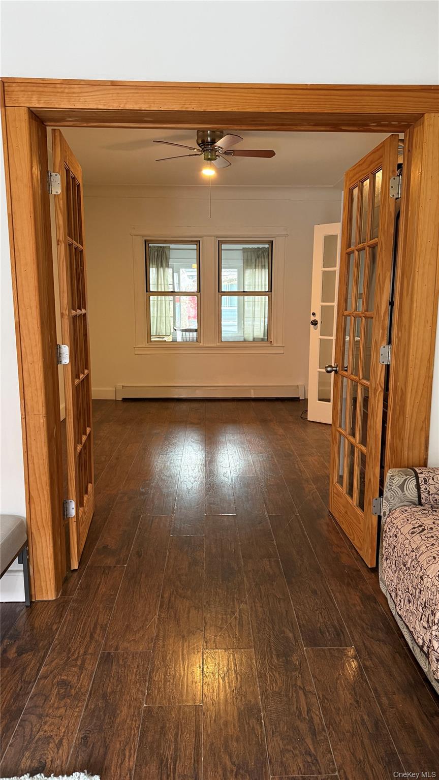 88-10 78th Street Queens, NY 11421 - Photo 5 of 19 a view of front door with wooden floor