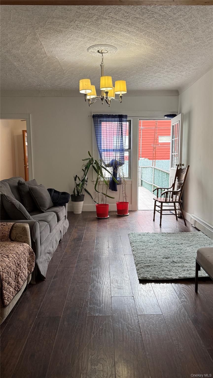 88-10 78th Street Queens, NY 11421 - Photo 8 of 19 a living room with furniture and a large window