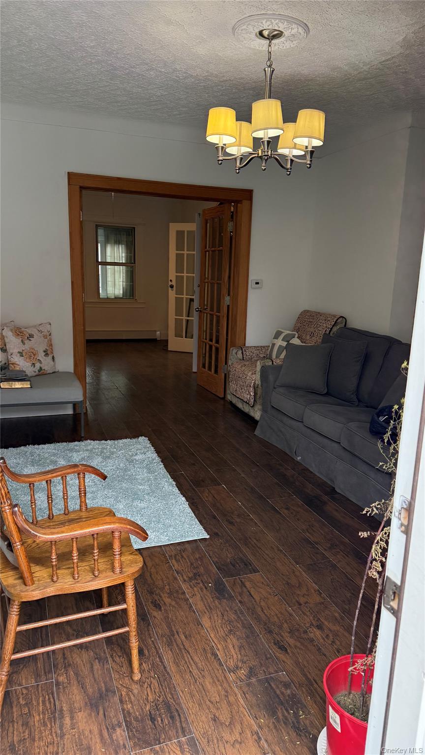 88-10 78th Street Queens, NY 11421 - Photo 9 of 19 a living room with furniture and a wooden floor