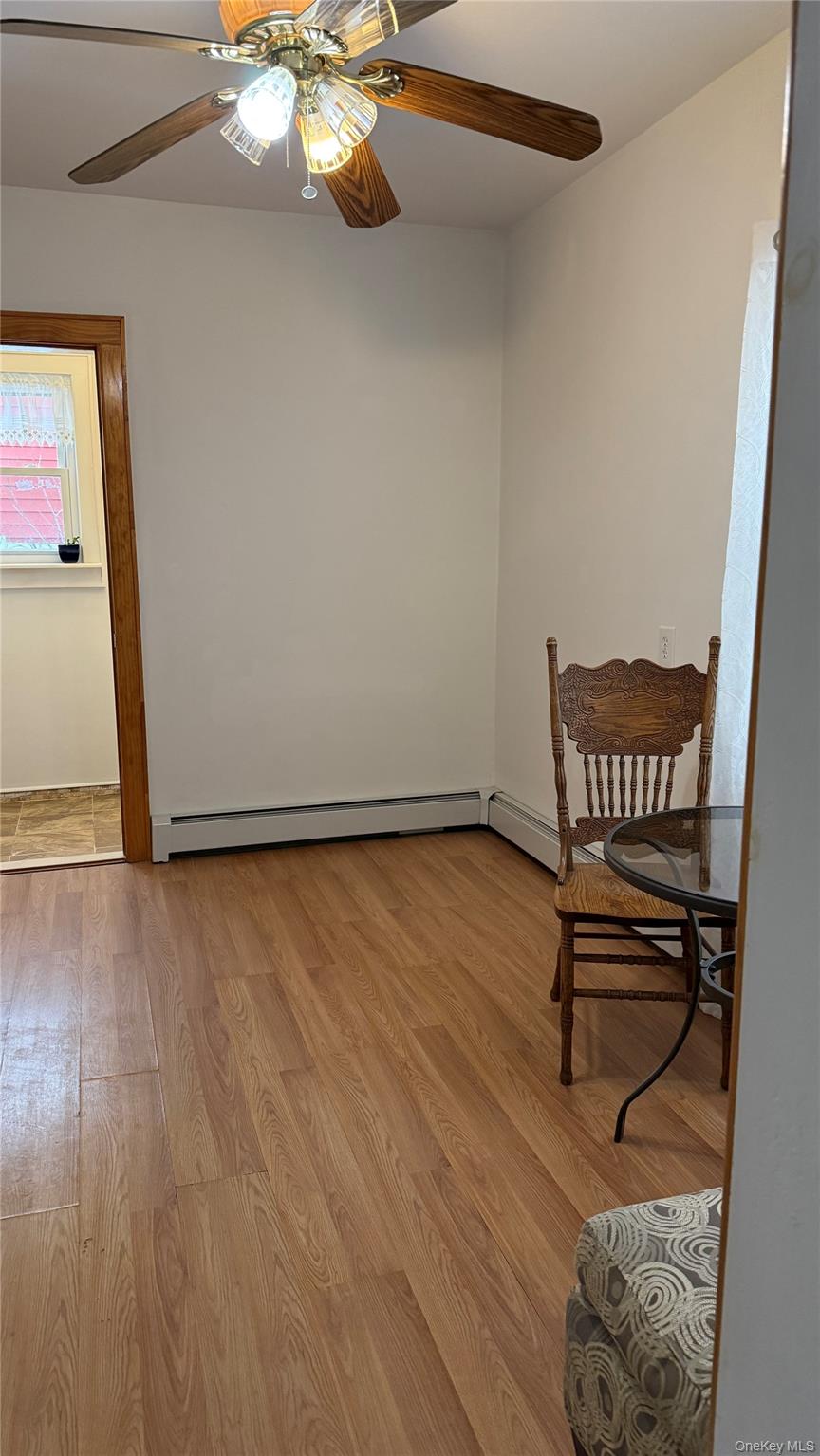 88-10 78th Street Queens, NY 11421 - Photo 10 of 19 a view of a room with wooden floor and a window