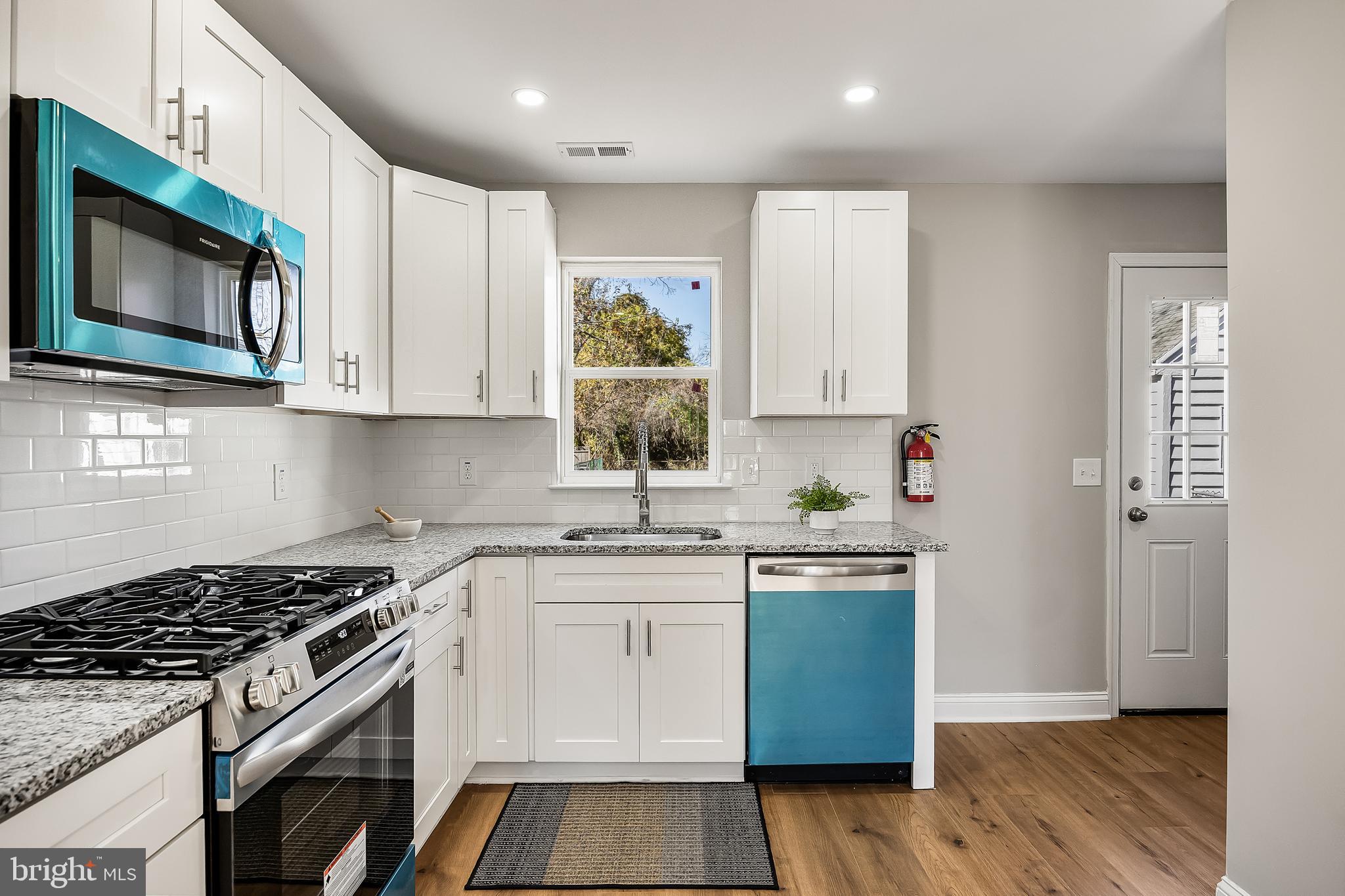 104 West Park Avenue Lindenwold, NJ 08021 - Photo 12 of 26 a kitchen with stainless steel appliances granite countertop a stove a microwave and a sink