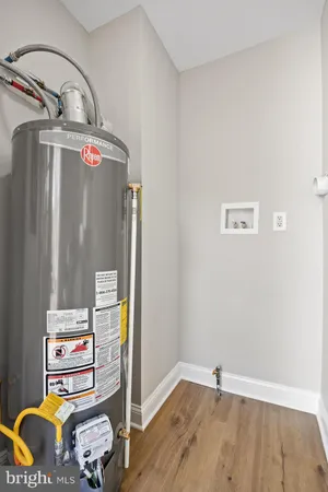 a view of storage and utility room with wooden floor