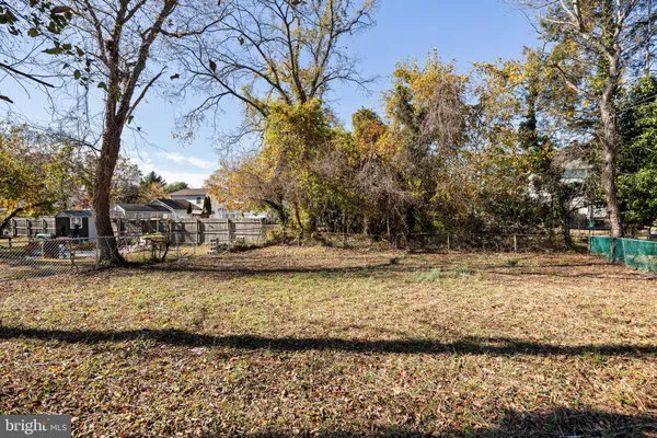 a view of a yard with wooden fence