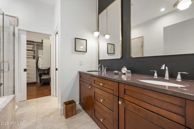 a spacious bathroom with a granite countertop sink mirror and shower