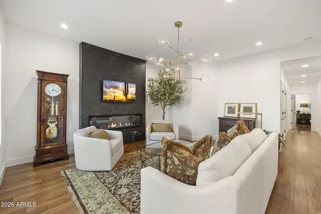 a living room with furniture and a chandelier