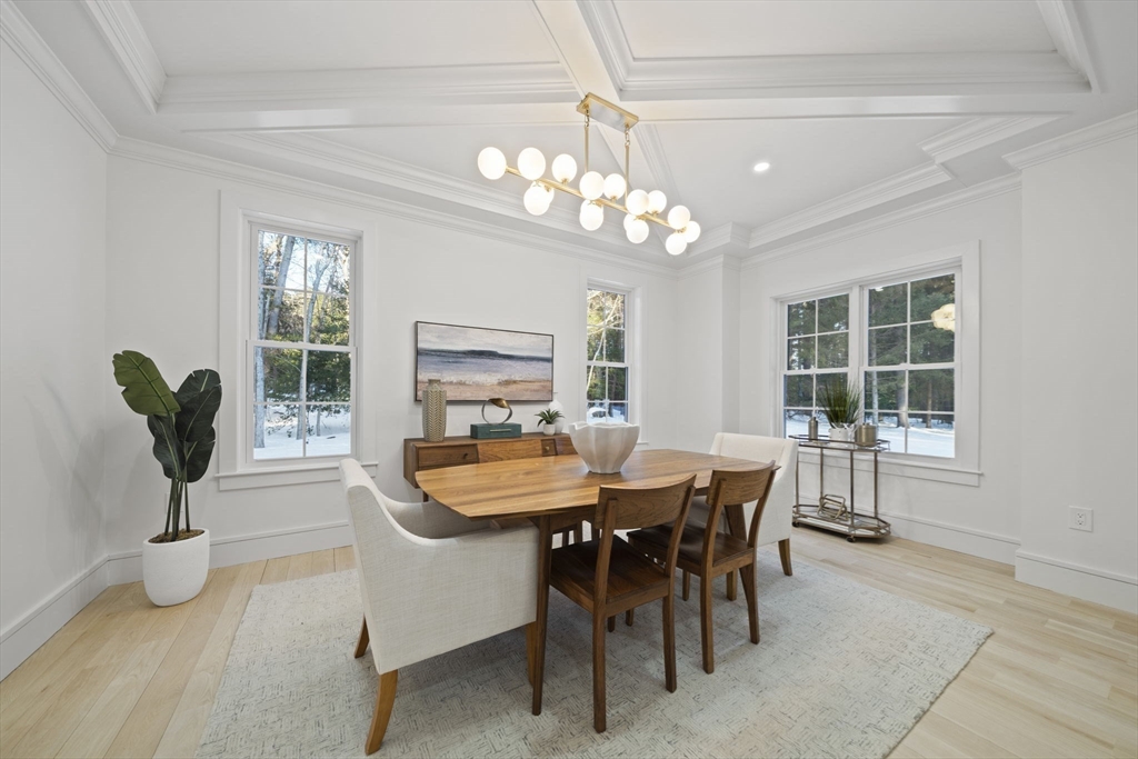 293 Cross Street Norwell, MA 02061 - Photo 12 of 42 a dining room with wooden floor a chandelier a wooden table and chairs