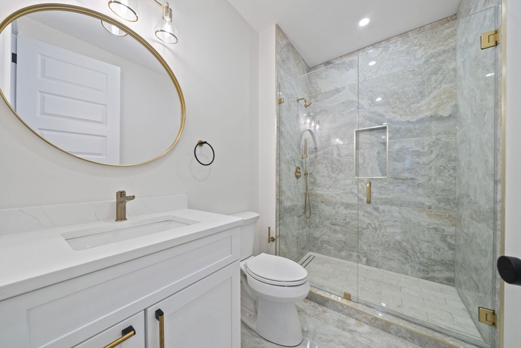 293 Cross Street Norwell, MA 02061 - Photo 15 of 42 a bathroom with a sink a toilet and a mirror