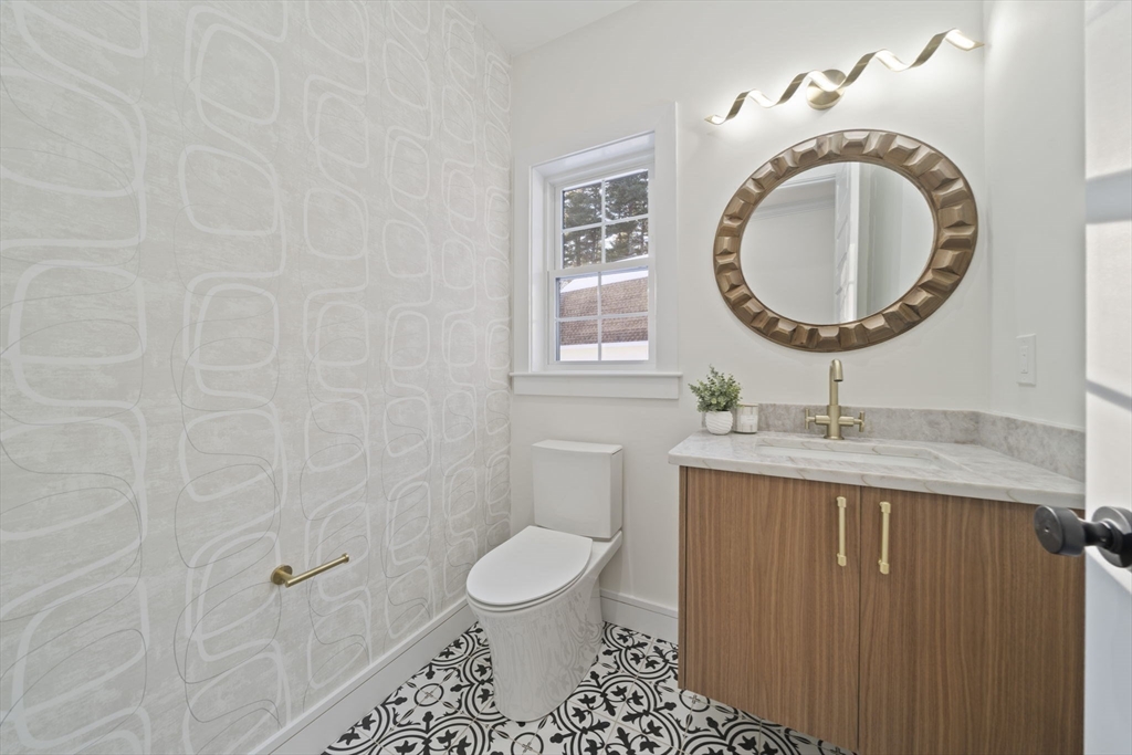 293 Cross Street Norwell, MA 02061 - Photo 18 of 42 a bathroom with a toilet a sink and mirror