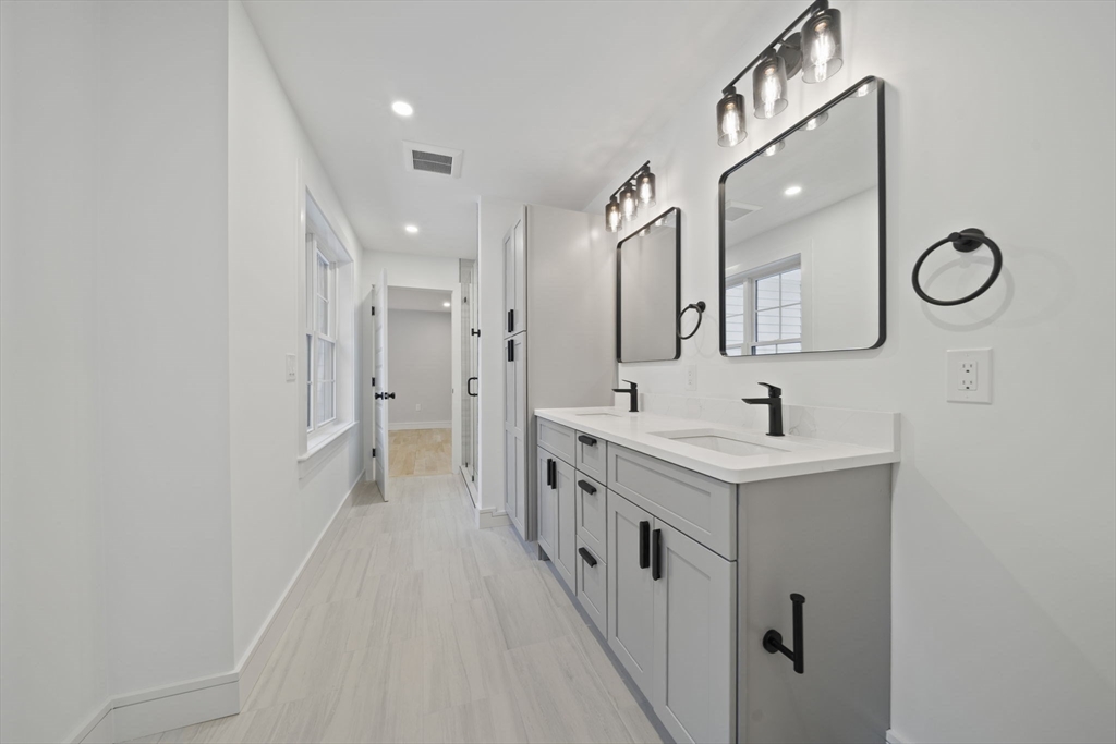293 Cross Street Norwell, MA 02061 - Photo 23 of 42 a bathroom with a double vanity sink mirror and