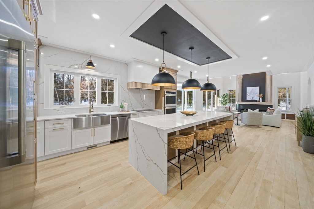 293 Cross Street Norwell, MA 02061 - Photo 3 of 42 a living room with stainless steel appliances kitchen island granite countertop lots of wooden furniture a sink and a refrigerator