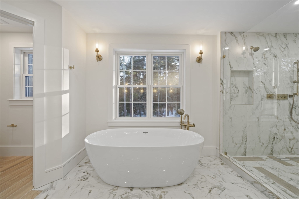 293 Cross Street Norwell, MA 02061 - Photo 32 of 42 a white bath tub sitting in a bathroom next to a window