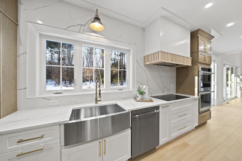 293 Cross Street Norwell, MA 02061 - Photo 5 of 42 a kitchen with stainless steel appliances a sink and cabinets