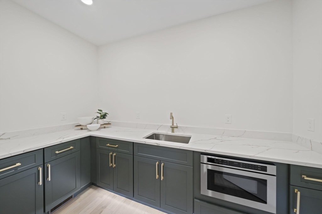 293 Cross Street Norwell, MA 02061 - Photo 6 of 42 a kitchen with a sink and cabinets