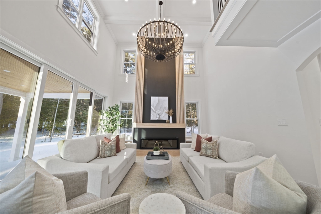 293 Cross Street Norwell, MA 02061 - Photo 10 of 42 a living room with furniture chandelier and a large window