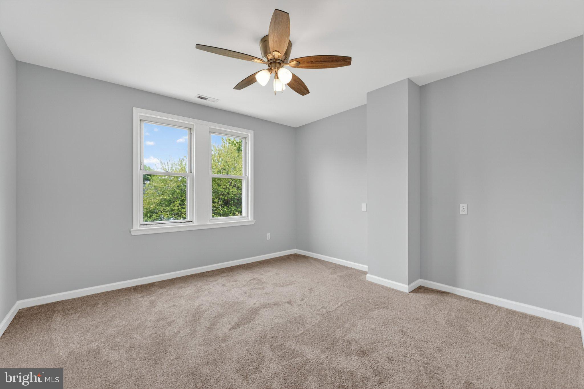 5312 Catalpha Road Baltimore, MD 21214 - Photo 56 of 59 an empty room with a window and a fan