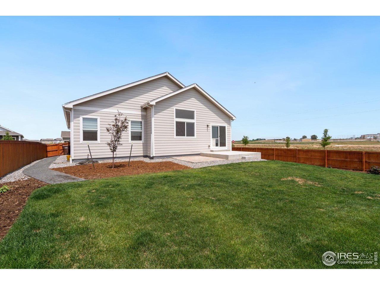 1247 Wild Basin Road Severance, CO 80550 - Photo 15 of 30 Side yard has crushed stone walkway and service door off side of garage for easy access; over $8k in landscaping spent in past year