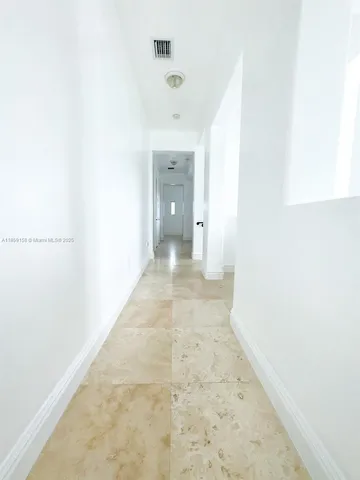 a view of a room with wooden floor and window