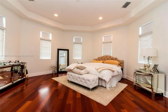 a large en suite bathroom with a tub double sink and mirror