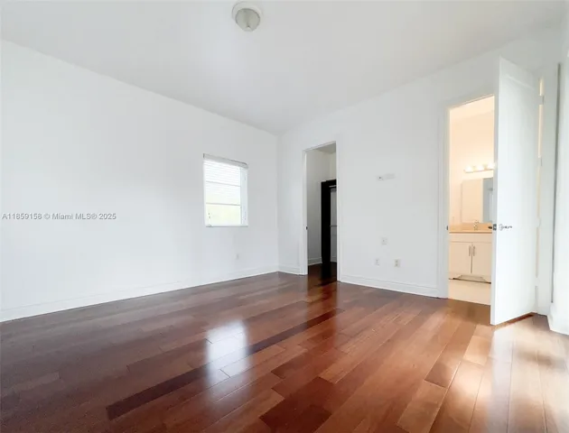 a bathroom with a granite countertop sink a toilet and a mirror