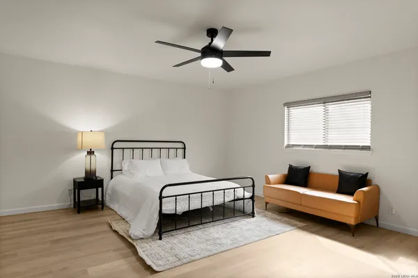 a bedroom with a bed and a couch