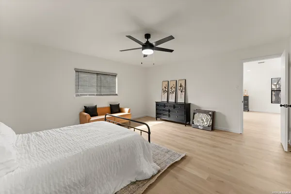 a bedroom with bed and a chandelier