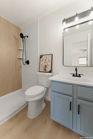 a bathroom with a toilet sink and mirror