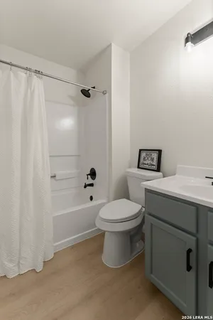a bathroom with a toilet sink and shower