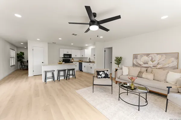 a living room with furniture and kitchen view