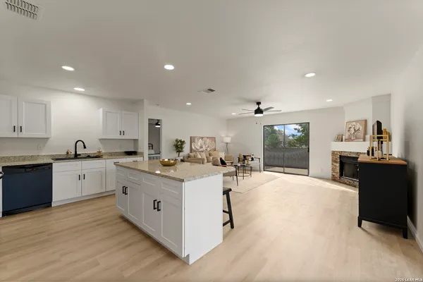 a kitchen with a sink stove and cabinets