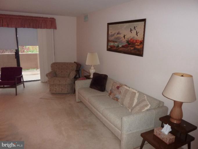 2903 Fallstaff Road, Unit 503 Baltimore, MD 21209 - Photo 12 of 20 a living room with furniture and a lamp