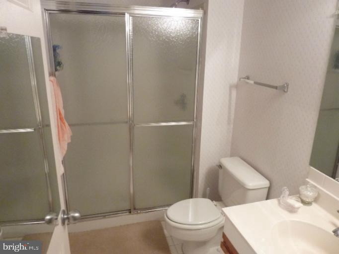 2903 Fallstaff Road, Unit 503 Baltimore, MD 21209 - Photo 15 of 20 a white toilet sitting next to a bathroom sink