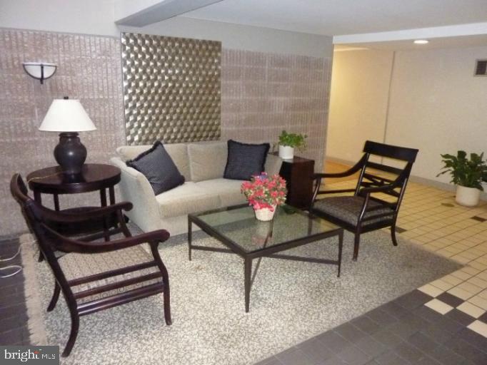 2903 Fallstaff Road, Unit 503 Baltimore, MD 21209 - Photo 3 of 20 a living room with furniture and a lamp
