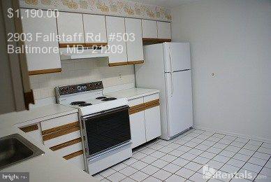 2903 Fallstaff Road, Unit 503 Baltimore, MD 21209 - Photo 7 of 20 a kitchen with stainless steel appliances a refrigerator and a stove top oven