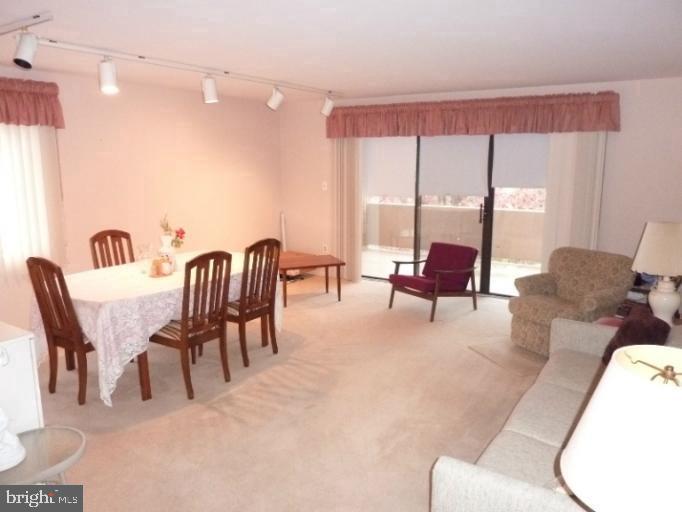 2903 Fallstaff Road, Unit 503 Baltimore, MD 21209 - Photo 8 of 20 a living room with furniture and a large window